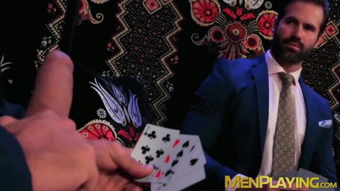 Suited man in blue tie holds cards as finger teases crotch in executive play