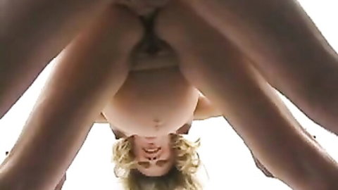 Upside-down closeup of pregnant blonde spreading legs wide exposing shaved pussy and swollen belly