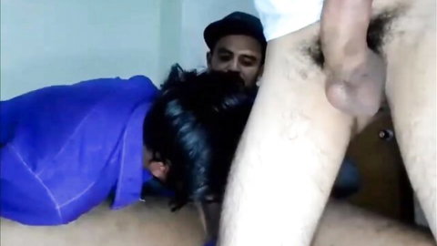 Bearded man in cap receiving blowjob from hooded figure in gangsta party