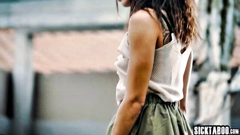 Curly-haired Latina MILF in white tank top and green skirt exploring Barcelona
