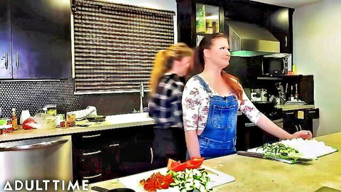 Lena Paul in casual denim overalls cooking veggies in kitchen BTS
