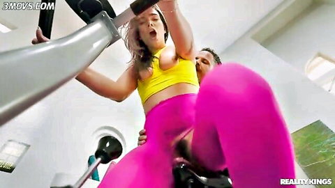 Muscular stud fucks brunette's tight ass in gym with pink yoga pants pulled down