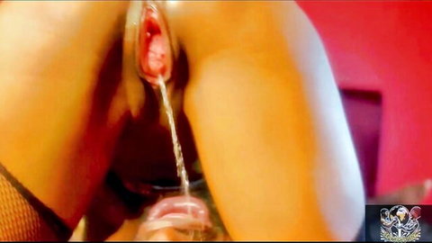 Close-up of soaked pussy squirting fluid into glass during climax