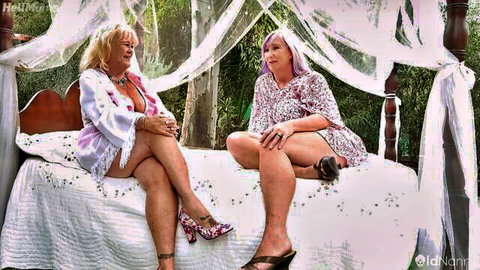 Inked mature beauty Melody Charm in sheer robe, teasing on bed with friend