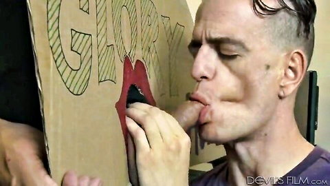 Gloryhole man's tongue yanked out through red lips by hand with drool dripping