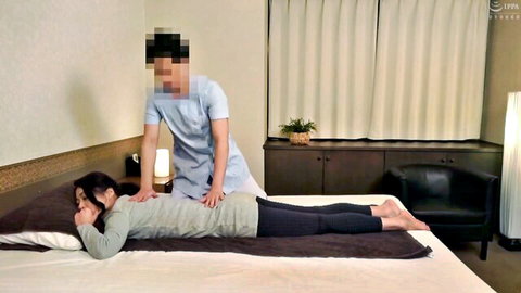 Japanese masseur rubs sexy East Asian babe's bare back during erotic massage