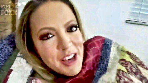 Carmen Valentina as stepmom smiling warmly under quilt in bed