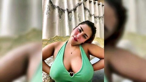 Chubby Indian babe with massive tits spilling from tight green halter top, deep cleavage tease