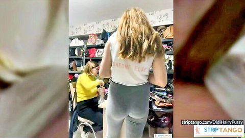 Blonde woman in tight gray leggings teasing ass in store chatroom