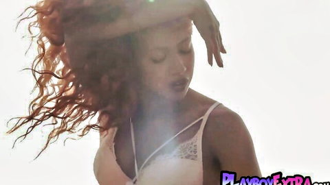 Ebony teen in white lace lingerie posing seductively in desert