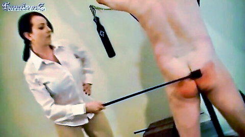 Miss Jessica Wood in femdom scene whipping naked man's ass with crop