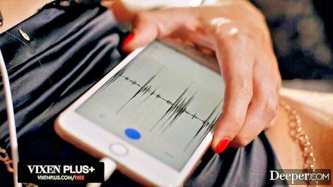 Sexy babe's hand grips phone showing wild shaking orgasm graph in black lingerie tease