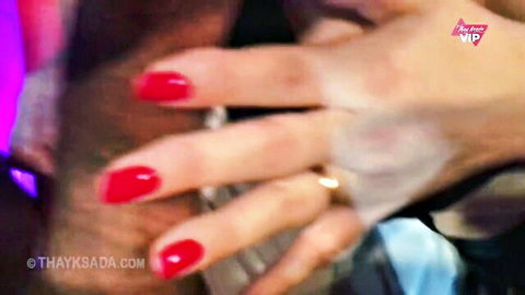 Woman's hand with red nails and wedding ring grips thick erect cock in closeup handjob