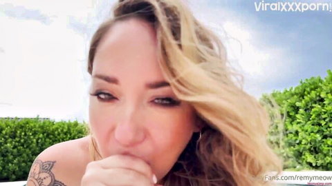 Remy LaCroix poolside closeup with teasing mouth gesture