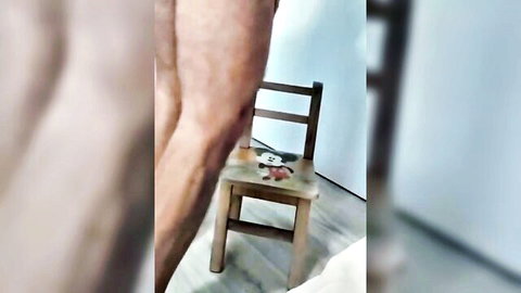 Muscular hairy thighs spread wide around wooden chair with toy teasing big cock