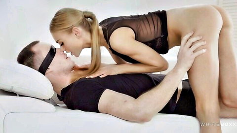 Blonde in sheer lingerie kisses blindfolded man in fetish romance scene