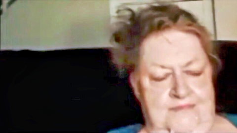 Mature granny with eyes closed receiving facial cumshot in HD video