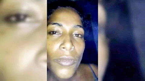 Close-up of seductive ebony woman's intense gaze in low light, amateur style