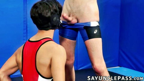 Gay wrestlers pull down singlets exposing cocks and asses in rough doggy position on mat