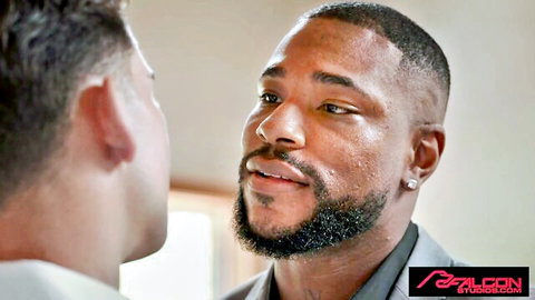 Two muscular Black men in suits with intense eye contact, gay adult video thumbnail
