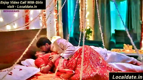Indian couple passionate kiss on wedding night in traditional attire