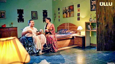 Desi woman in colorful dress with wheelchair-bound man in intimate scene