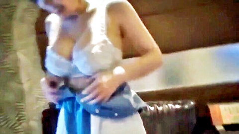 Busty short-haired Japanese babe squeezing huge tits in revealing white lace top with blue sash