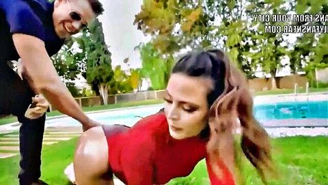 Curvy brunette in red bodysuit grabbed by man in doggy pose poolside