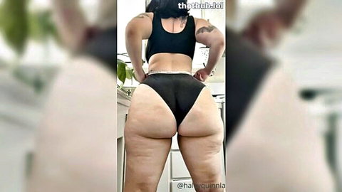 Thick BBW brunette with massive cellulite ass cheeks spilling out of tiny black thong posing in kitchen
