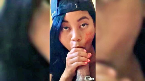 Asian woman in Nike cap giving intense blowjob, deepthroating cock