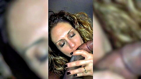 Curly blonde woman teasing big black dildo with plump lips, intimate close-up