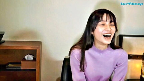 Smiling Japanese office lady Miwa in purple turtleneck sweater