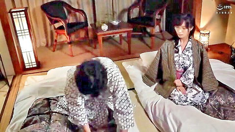 Japanese couple in traditional yukata on futon bed in tatami room foreplay
