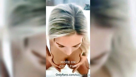 Blonde OnlyFans model teasing with large breasts and cleavage