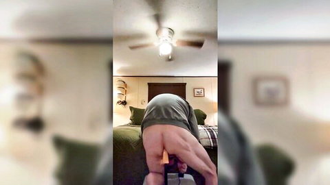 Muscular man bent over taking large orange anal toy in ass