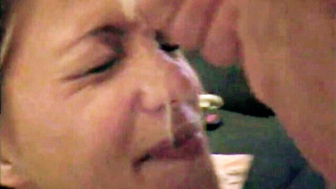 Close-up of amateur blonde woman with cum on face after facial cumshot