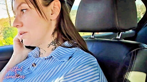 Hairy mature MILF with neck tattoos in striped shirt on phone in car
