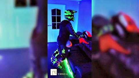 Fetlads in neon green motocross gear, helmet and boots, posing solo with bike