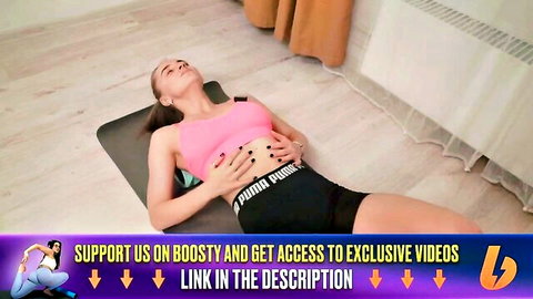 Alina in pink sports bra and black shorts doing relaxing foam roll stretch on yoga mat