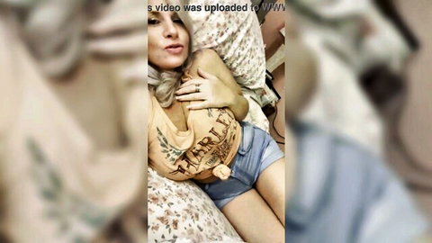 Blonde cougar Rosie seductively posing in tank top and shorts