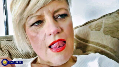 Amateur mature blonde Ellie teases tongue out in white top, solo dildo play