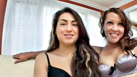 Sasha Stevens in black bra embracing brunette latina in pink lingerie, lesbian tease