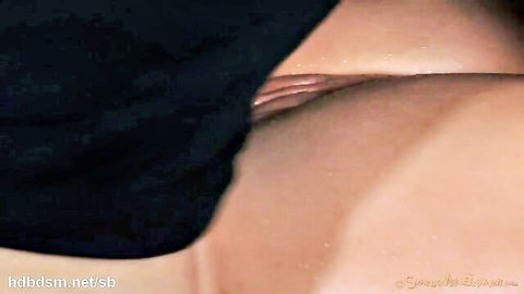 Close-up of bound woman's exposed pussy in black dress, bondage tease