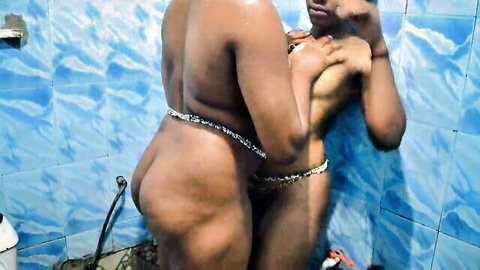 Thick Afro lesbian babes embracing nude in steamy shower bath