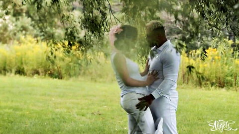 Emma Rose in passionate outdoor embrace with partner under tree