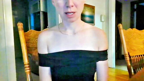 Webcam girl in tight black off-shoulder dress shows deep cleavage with mouth wide open teasing blowjob
