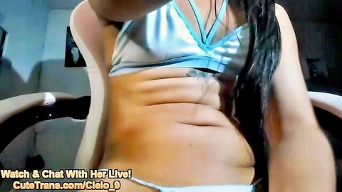 Amateur trans girl in blue lingerie teasing on webcam, showing midriff