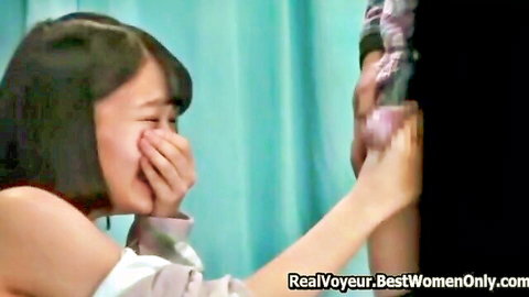 Japanese woman laughing coyly with partner in intimate public moment, Asian couple tease