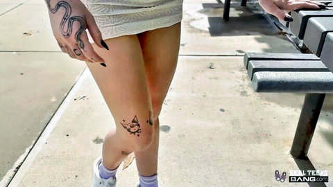 Delilah Dagger in short lace dress, tattoos on arm and knee, sexy outdoor walk