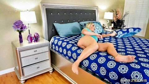 Blonde bombshell in blue bra spreads legs teasing on bed